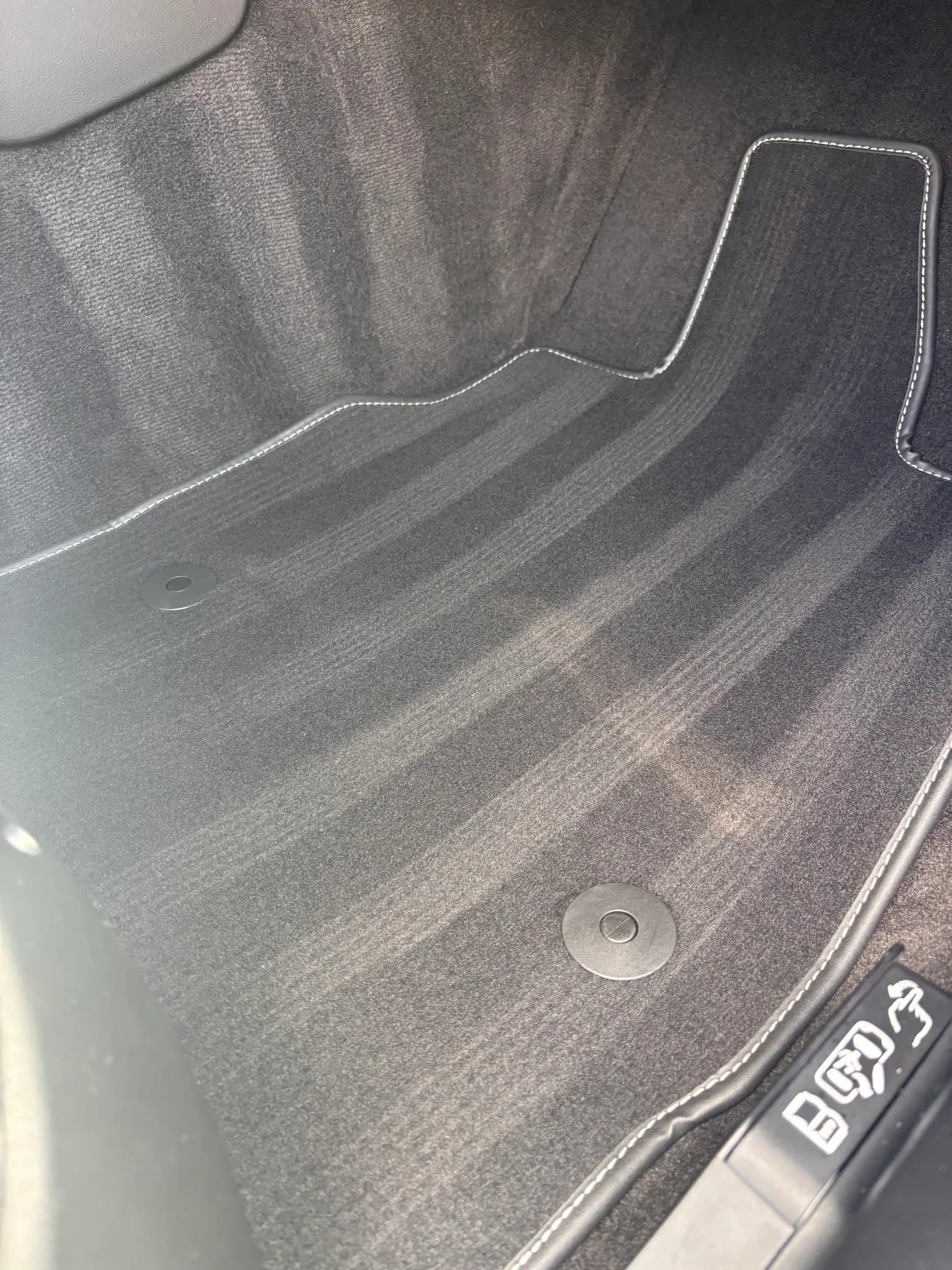 Close-up of a vacuumed Audi floor mat showing fresh carpet nap lines.