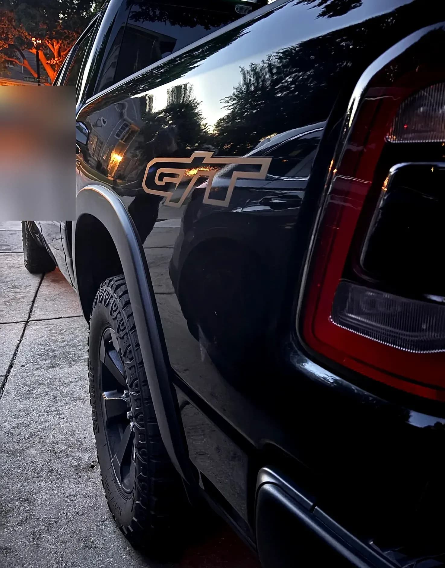 Close-up of the GT emblem on a black Ram rear quarter panel.