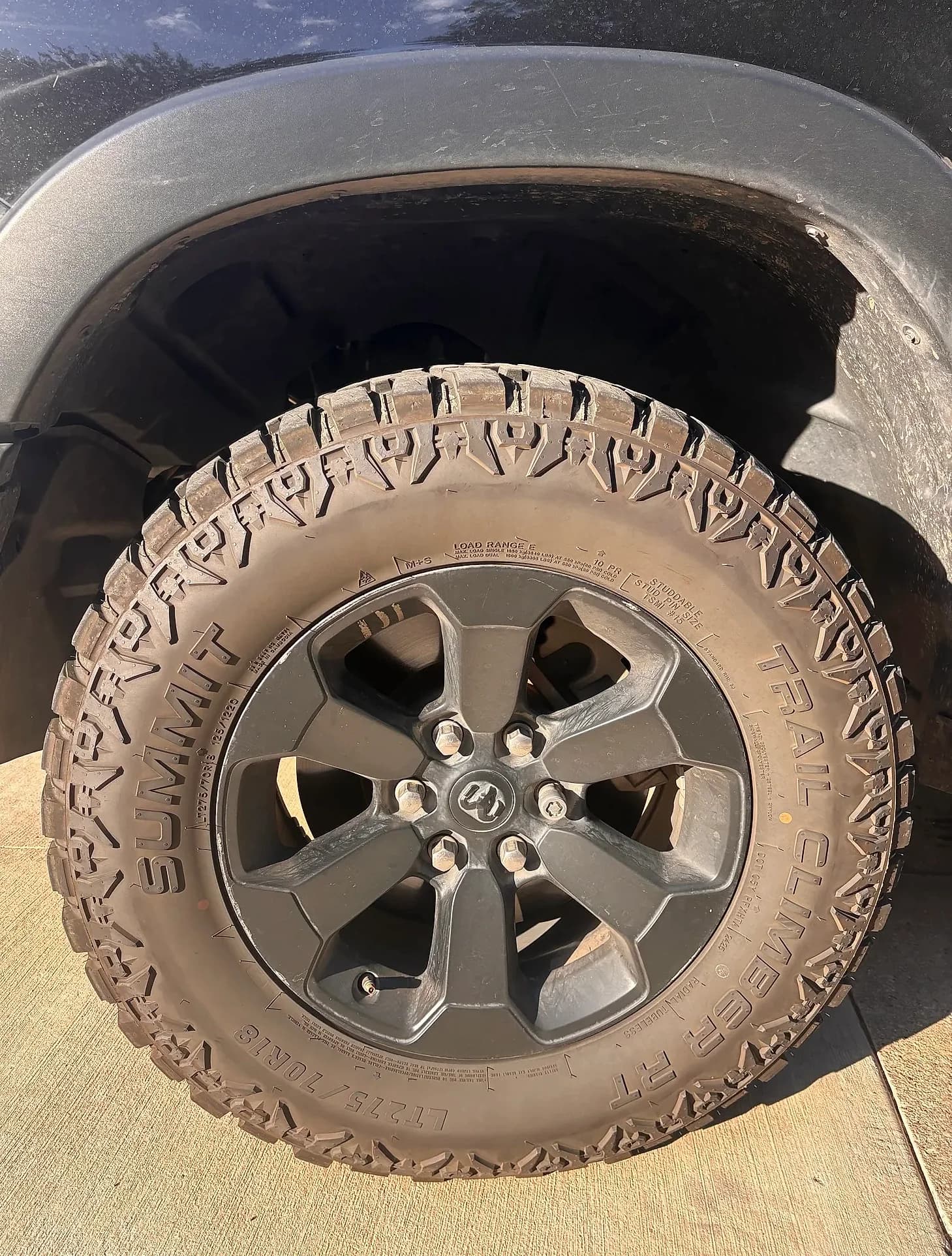 Cleaned alloy wheel and tire on a black Ram 1500.