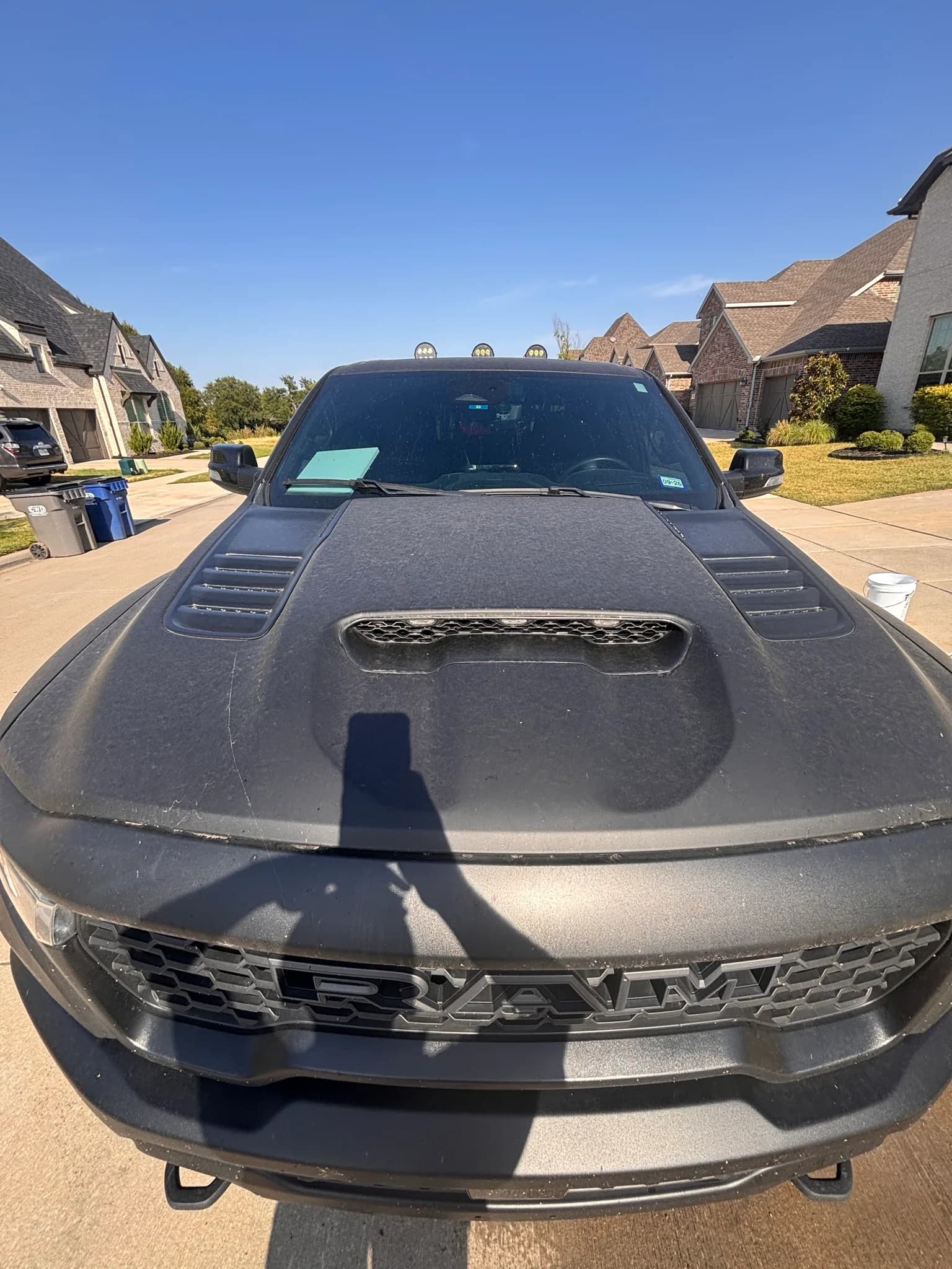 Hood scoop and RAM grille of a matte grey 1500 TRX, dust sitting visibly on the flat paint.