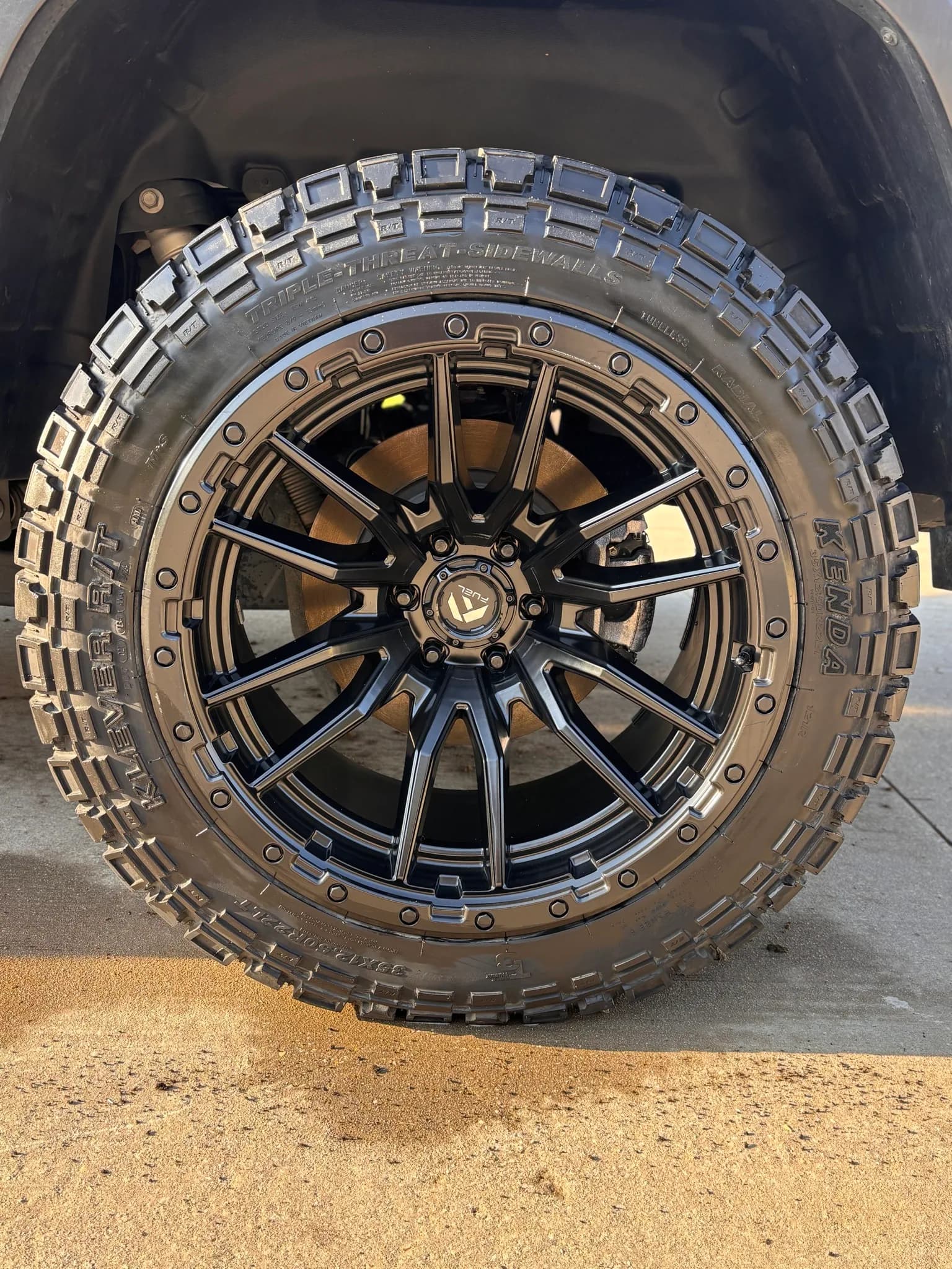 Cleaned off-road wheel and mud-terrain tire on a Ram 1500 TRX.