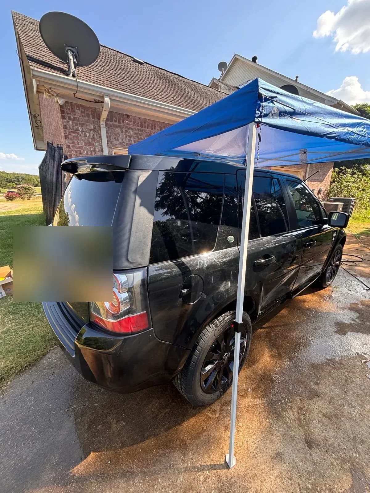 Clean black Land Rover LR2 with reflective paint after detailing.