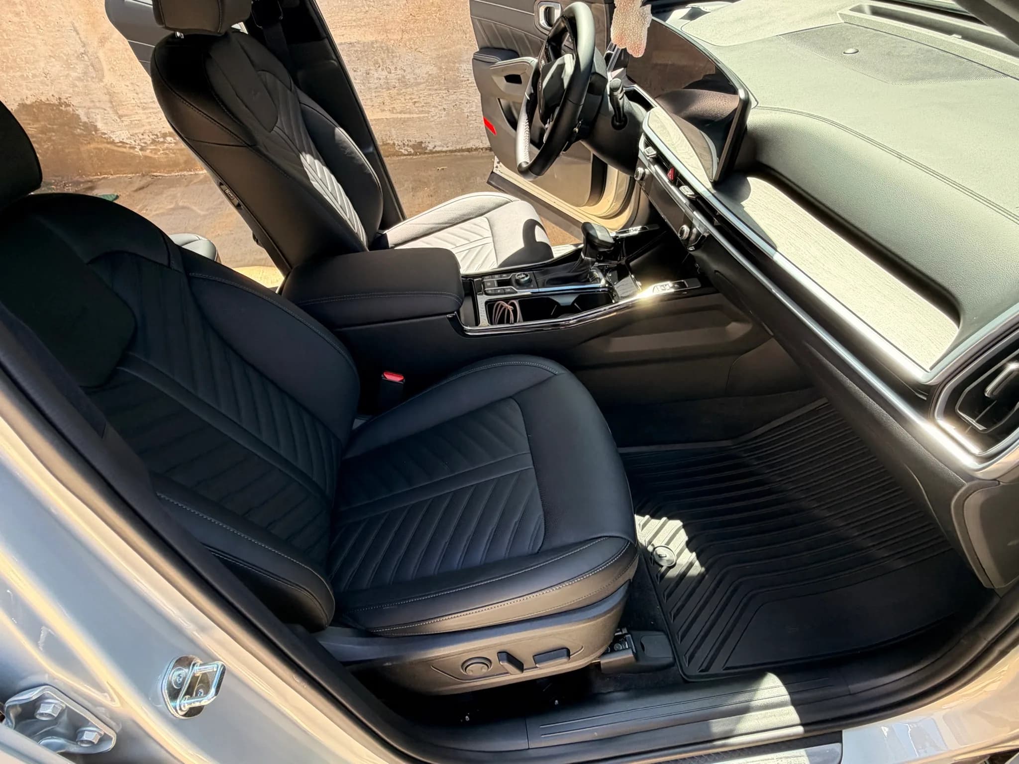 Clean front seats, dashboard, console, and floor inside a Kia Sorento.