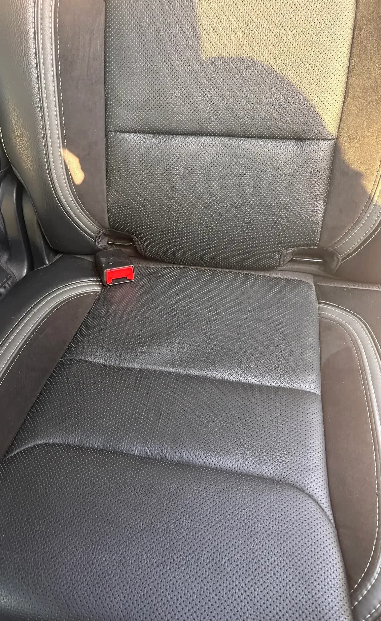 Clean black perforated leather rear seat cushion.