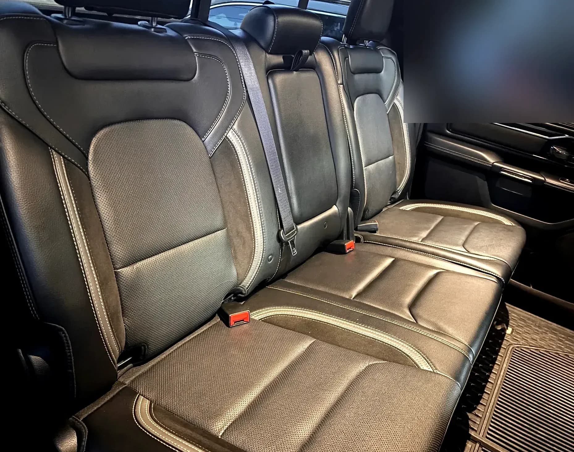 Detailed rear cabin of a black Ram 1500, wide view.