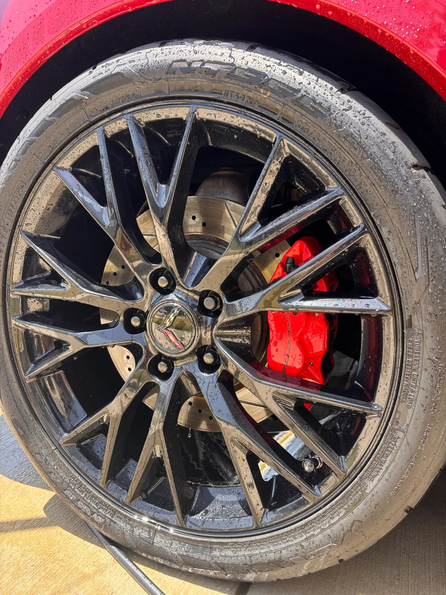 Brake-dust covered Corvette wheel and tire before cleaning.