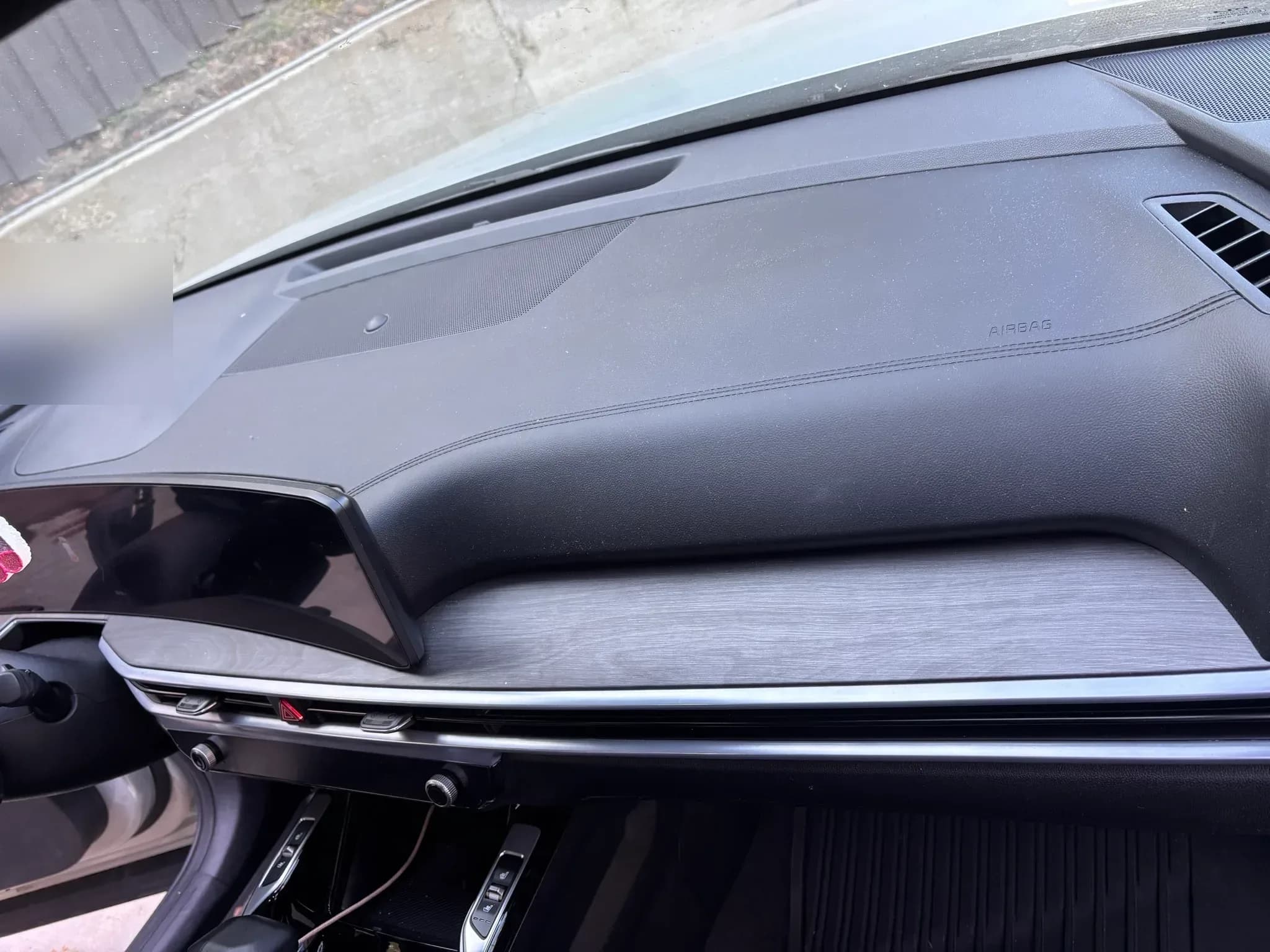 Dust visible across the passenger side dashboard of a Kia Sorento before cleaning.