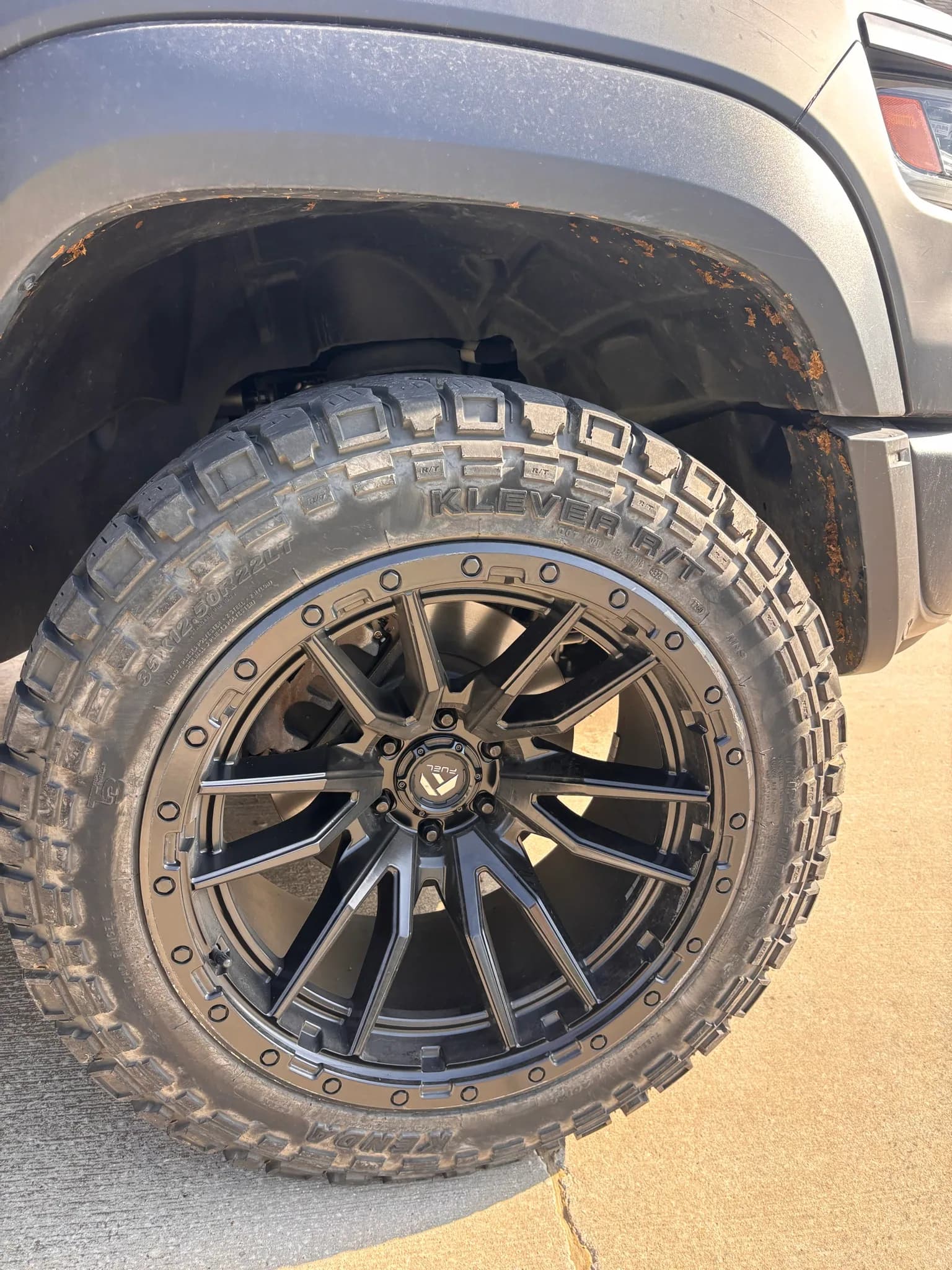 Dirt-covered wheel, tire and wheel arch on a Ram 1500 TRX before the wash.